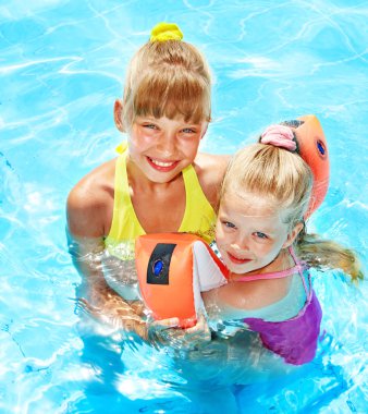 Child with armbands in swimming pool clipart