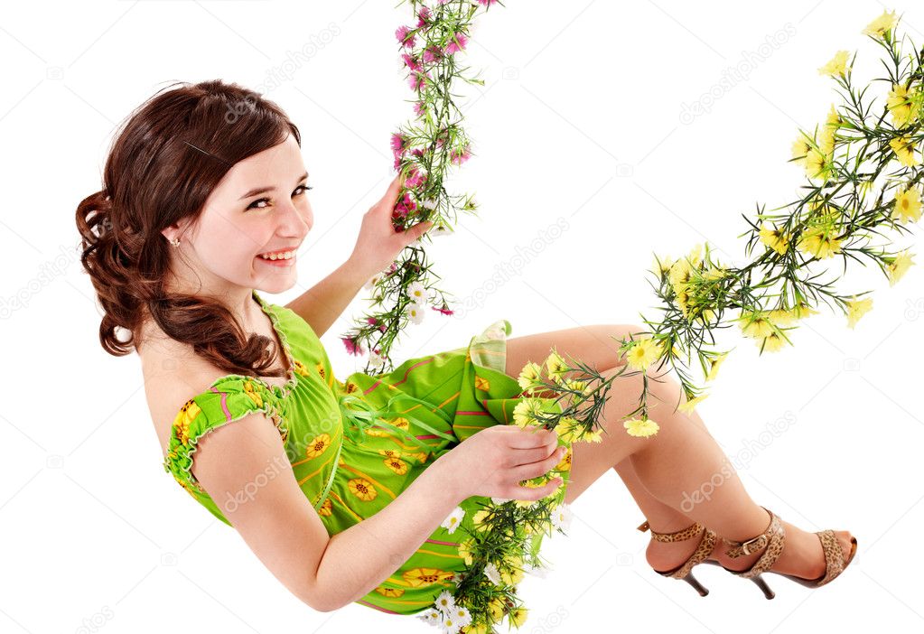 Beautiful girl swinging on flower swing.