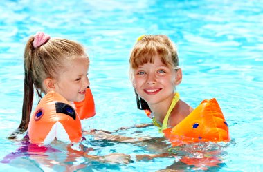 Children in swimming pool. clipart