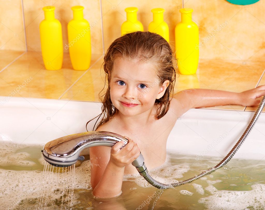 Child washing in bubble bath .