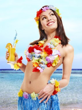 Woman in hawaii costume drink juice. clipart