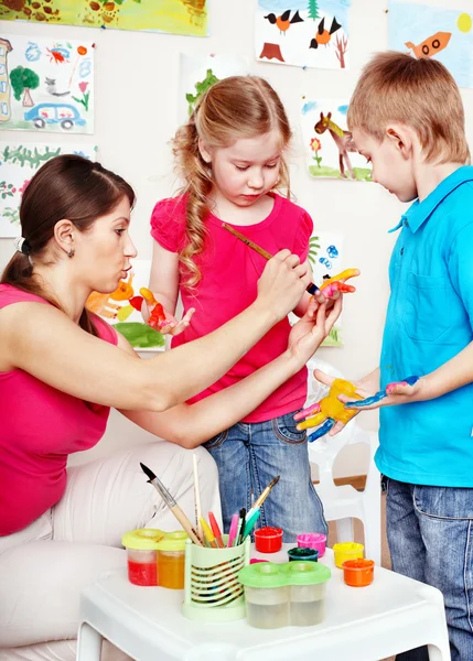 Children painting with teacher . — Stock Photo, Image