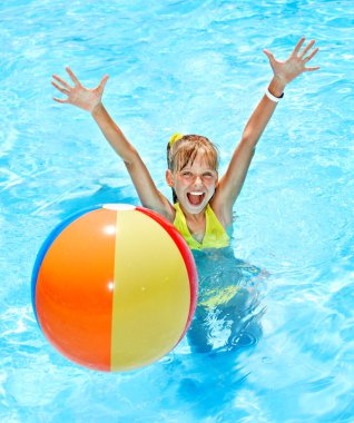 Child swimming in pool. clipart