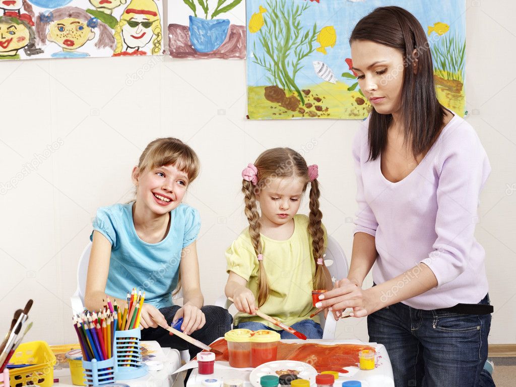 Children painting in preschool.
