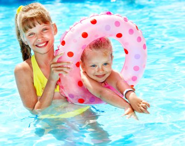 Child sitting on inflatable ring. clipart