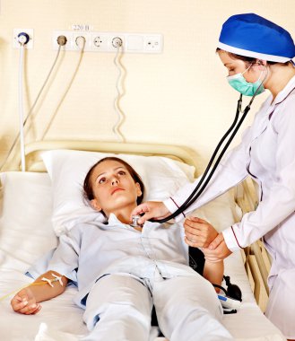 Doctor treats patient with stethoscope. clipart