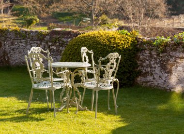 Garden table and chairs on lawn clipart