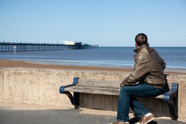 Senior man looking out over beach at Southport — Stock Photo, Image