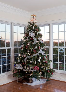 Decorated christmas tree in home clipart