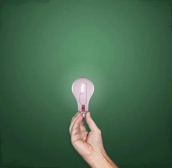 Bright idea lightbulb in hand — Stock Photo, Image