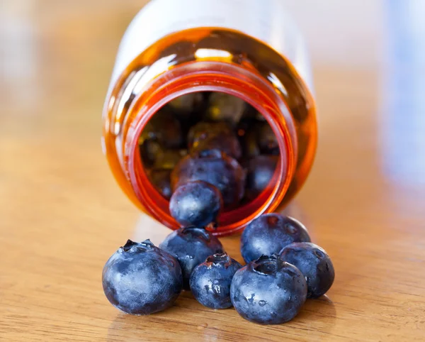 Blueberries in drug bottle — Stock Photo, Image