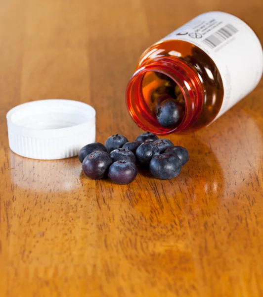 Blueberries in drug bottle — Stock Photo, Image