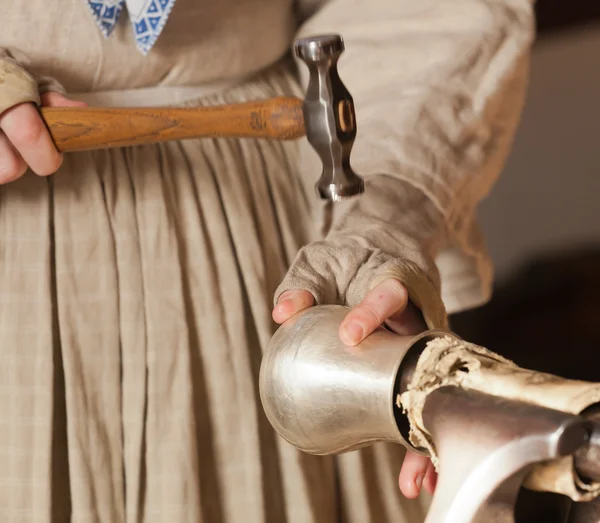 Lady hammering silver mug — Stock Photo, Image