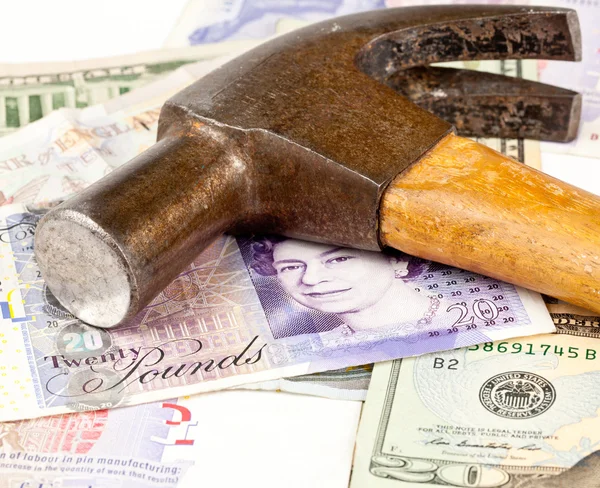 Hammer on top of pound note — Stock Photo, Image