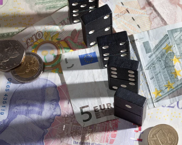 Standing dominoes on bank notes — Stock Photo, Image
