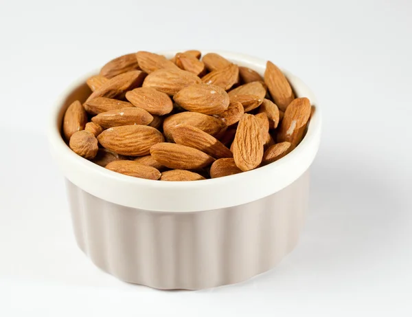 Raw organic almonds in bowl — Stock Photo, Image