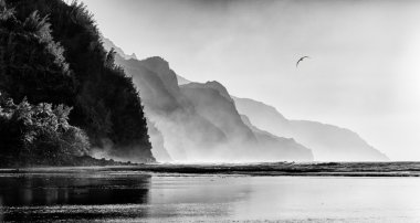 Misty sunset on Na Pali coastline clipart