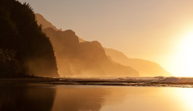 Misty sunset on Na Pali coastline clipart