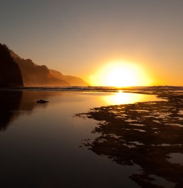 Misty sunset on Na Pali coastline clipart