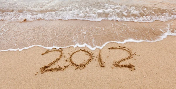 2012 written in sand with waves — Stock Photo, Image