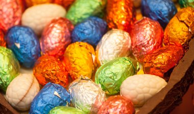 Foil wrapped easter eggs in chocolate egg clipart