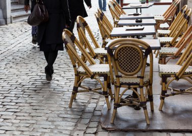 Empty cafe tables in Brussels cobbled square clipart