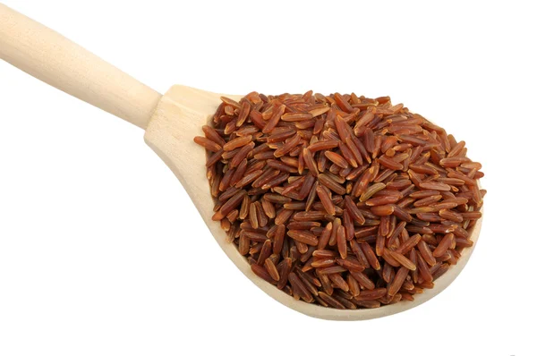 Red rice on wooden spoon — Stock Photo, Image