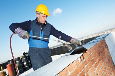 Flat roof covering works with roofing felt clipart
