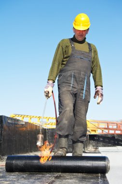 Flat roof covering works with roofing felt clipart