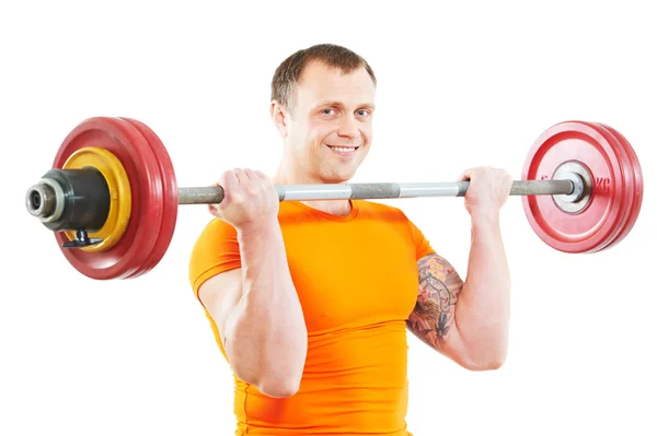 Homem fisiculturista fazendo exercícios com peso — Fotografia de Stock