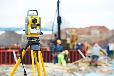 Surveyor equipment theodolite at construction site clipart