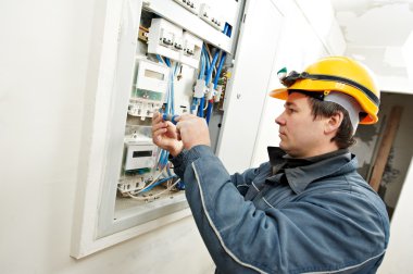 Electrician installing energy saving meter clipart