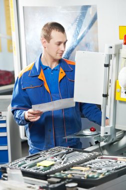 Worker at machine tool in workshop clipart