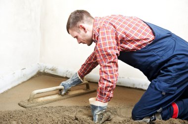 Plasterer concrete worker at floor work clipart