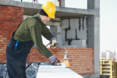 Flat roof covering works with roofing felt clipart