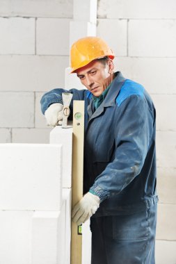 Construction mason worker bricklayer with level clipart