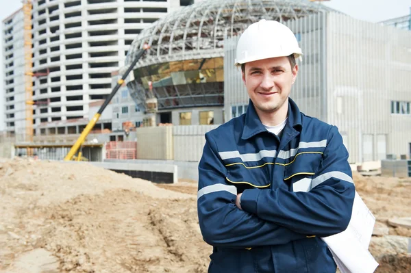 Foreman at construction site with working drawings — Stock Photo, Image