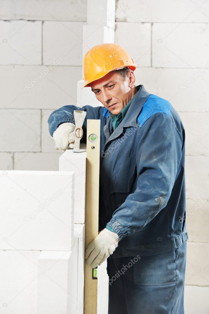 Construction mason worker bricklayer with level