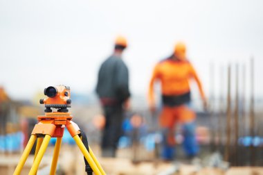 Surveyor equipment level at construction site clipart