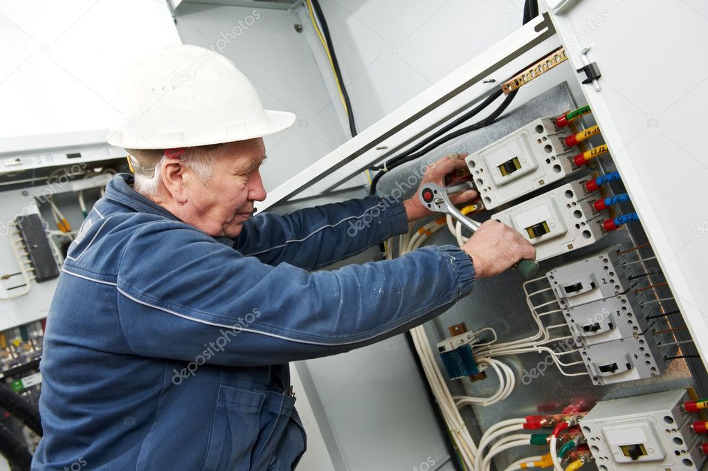 Electrician tighten the screws with spanner ⬇ Stock Photo, Image by ©  kalinovsky #8017196