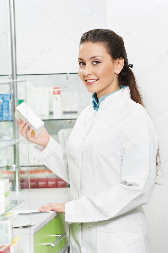 Smiling Pharmacy chemist woman in drugstore
