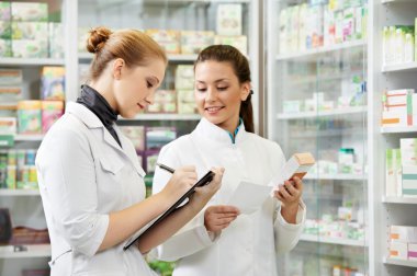 Pharmacy chemist women in drugstore clipart