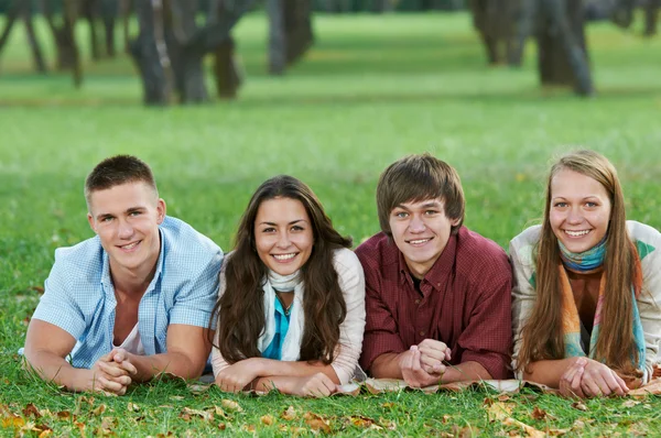Группа улыбающихся молодых студентов на открытом воздухе Лицензионные Стоковые Изображения