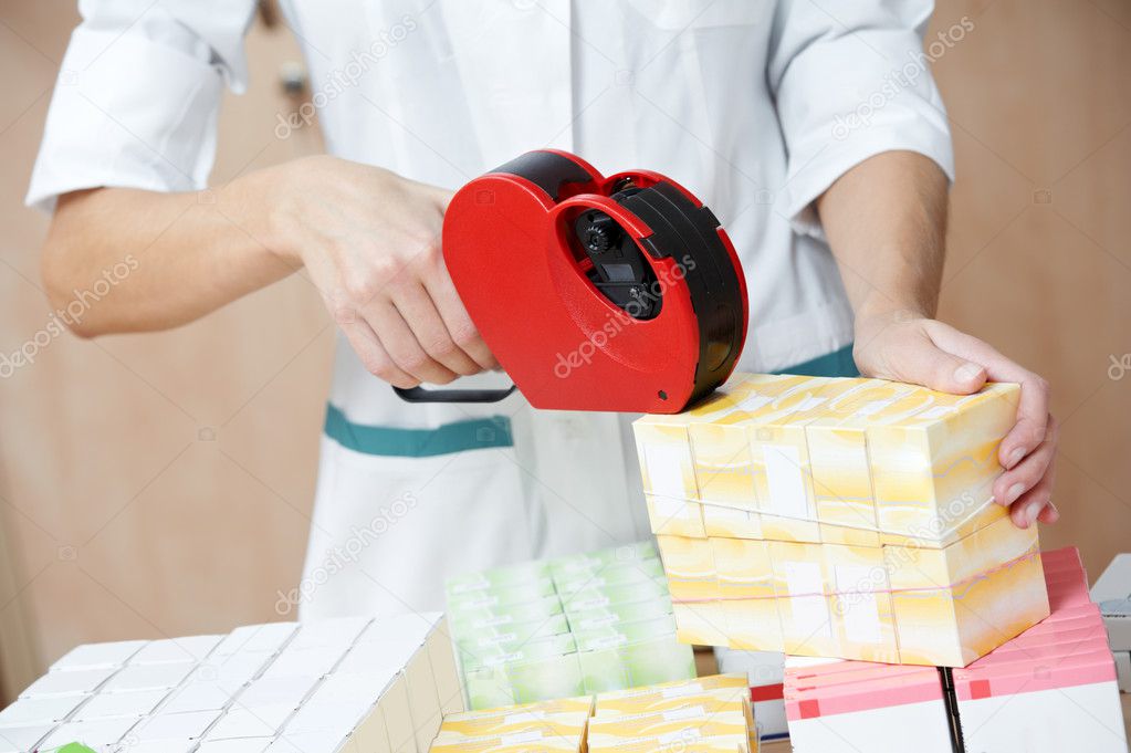 Pharmacy chemist woman labeling drugs