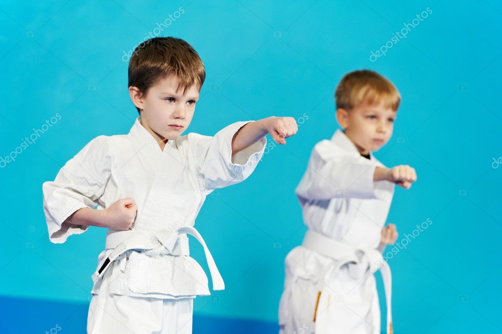 Two boys make karate exercises