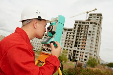 Surveyor works with theodolite clipart