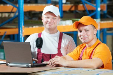 Manual workers in warehouse clipart