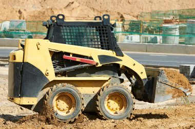 Skid steer loader at earth moving works clipart