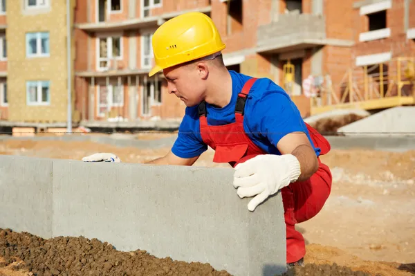 Builder installing road concrete kerb — Stock Photo, Image