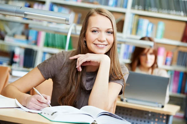 Young student girl working with book at library Royalty Free Stock Photos